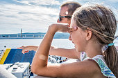 Daughter and Father Enjoy on the Ferry Boat Deck in Sunny Day Traveling on Vacation