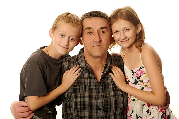 Daughter and son embraced his father stock photo