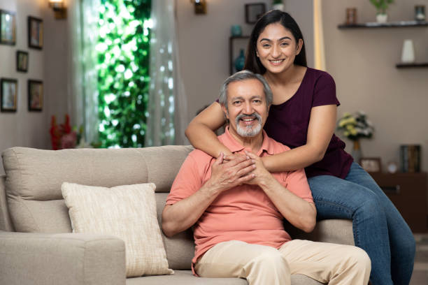 daughter embracing her father at home :- stock photo stock photo