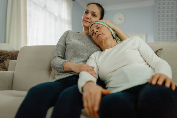 daughter  supporting and hugging her Mom with cancer daughter  supporting and hugging her Mom with cancer cancer illness stock pictures, royalty-free photos & images