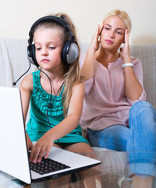daughter using laptop instead of studying Terrified mother watching daughter using laptop instead of studying at home familyporn stock pictures, royalty-free photos & images