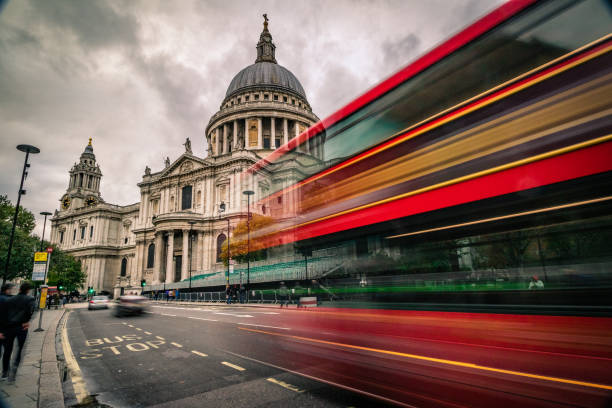 Day time view of Saint Paul's Cathedral in London city - creative stock image Long exposure, cloudy weather day time view of Saint Paul's Cathedral in London city with motion blur traffic, including:(double decker bus, cars, tourists and commuters). Shot on Canon EOS R full frame system with extra wide lens for premium quality. central london stock pictures, royalty-free photos & images