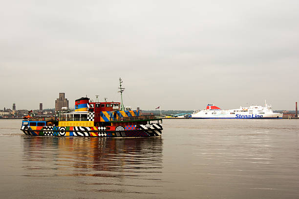 Dazzled Mersey Ferry and Stena line ship Liverpool, UK - June 4, 2016: The famous Mersey Ferry in dazzle colours.  The eye-catching dazzle design is in honour of the patterns that were first used on vessels in World War One. They worked by ‘baffling the eye’ and making the ships difficult to target. merseyside stock pictures, royalty-free photos & images