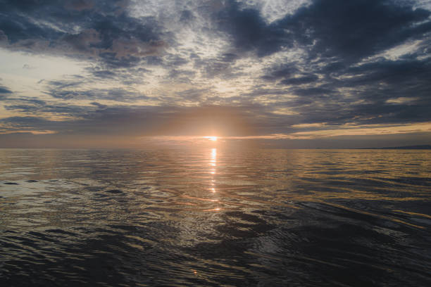 Dazzling morning sun floating in the deep sea stock photo