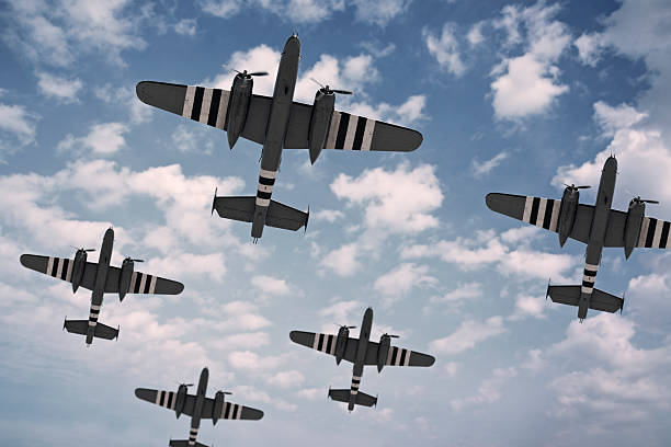 D-Day Dawn A formation of five North American B-25 Mitchells, painted with D-Day invasion stripes.. military invasion stock pictures, royalty-free photos & images