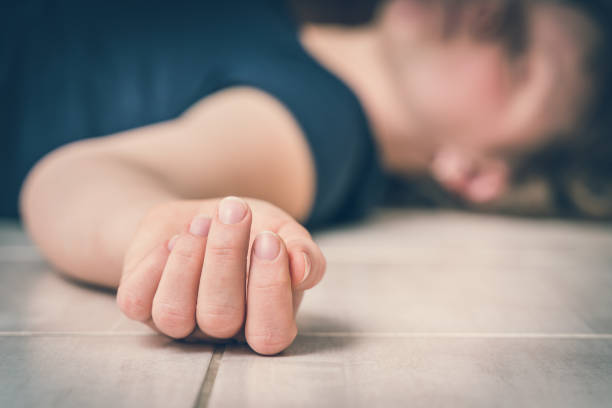 Dead woman lying on the white floor Dead woman lying on the white floor - suicide concept dead people stock pictures, royalty-free photos & images