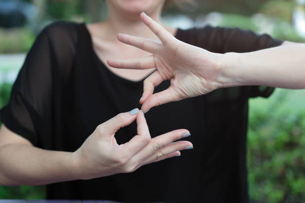 Deaf woman using sign language stock photo