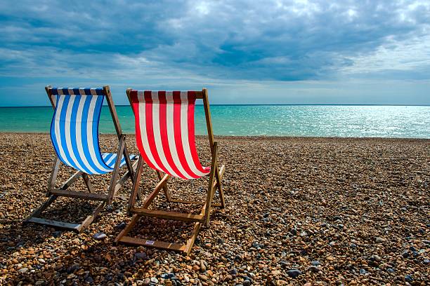deck chairs on beach - brighton stok fotoğraflar ve resimler