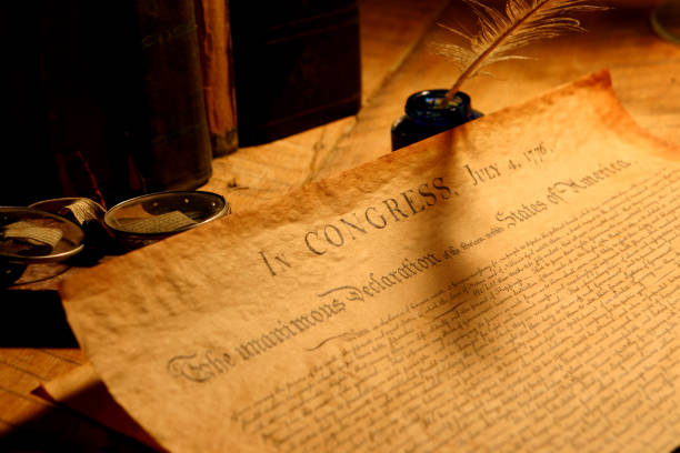 Declaration of Independence Decleration of Independence, focus is on the word Congress. Ink feather pen, glasses and old books in the background. declaration of independence stock pictures, royalty-free photos & images