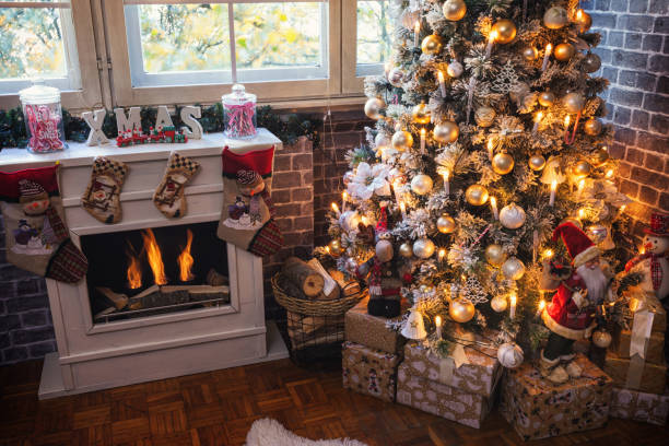 Decorated Christmas Tree Near Fireplace at Home stock photo