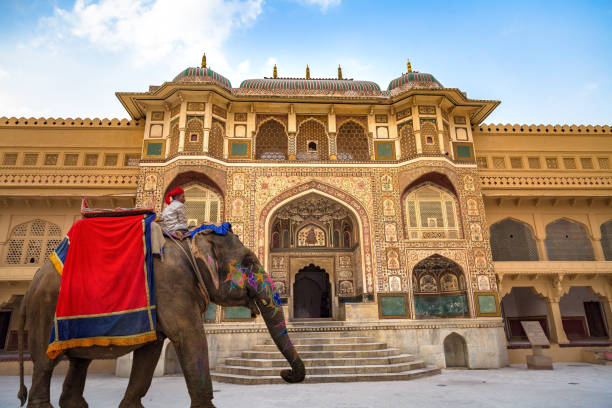 Decorated Indian elephant in front of Amer Fort Palace Jaipur intricately carved gateway. Amber Fort is a UNESCO World Heritage site. stock photo