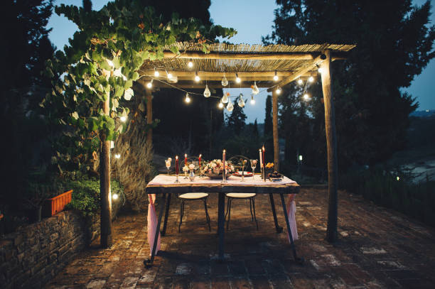Decorated outdoor wedding table with flowers in rustic style stock photo