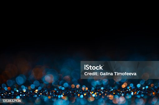 istock Decoration twinkle glitters background, abstract shiny backdrop with circles,modern design wallpaper with sparkling glimmers. Black, blue and golden backdrop glittering sparks with blur effect. 1313832936