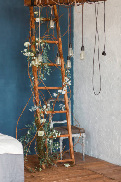 decorative antique edison style light bulbs against wooden ladder background. lights on the background of blue wall - spot light orange imagens e fotografias de stock