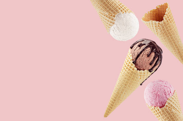 decorative border of fly different flavor ice cream cones in waffle - white, pink, brown with chocolate sauce on pink. - ice cream imagens e fotografias de stock