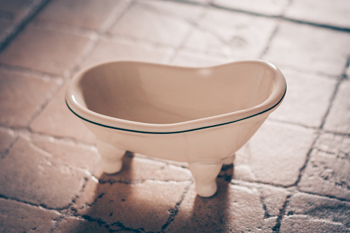 Decorative ceramic tub on legs, selective focus