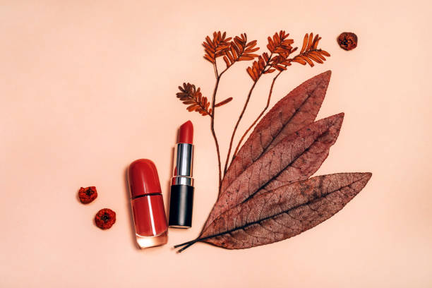 Decorative flat lay composition with cosmetics and Autumn leaves stock photo