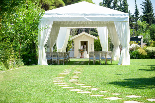 Decorative place for ceremonies or entertainments. Outdoor reception under tents and trees stock photo