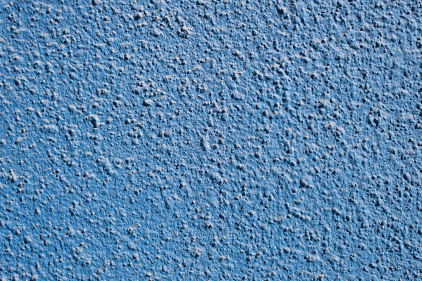 textura de pared decorativa, áspera y desigual en azul - desigual con textura fotografías e imágenes de stock