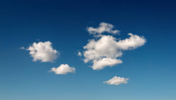 Deep blue sky with few clouds stock photo