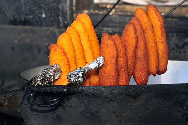 Deep fried alcapurrias hanging to cool stock photo