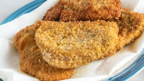 Deep fried breaded pork chops close up on plate stock photo