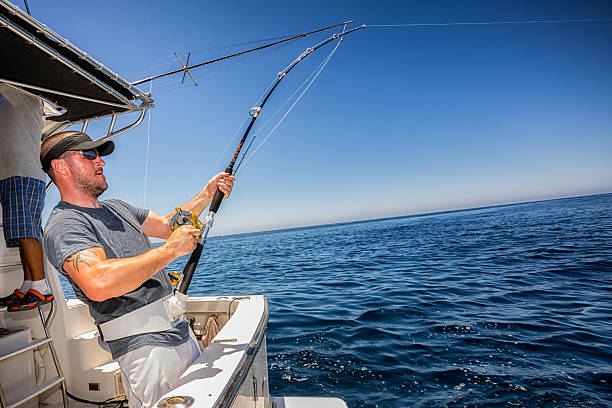 Deep Sea Fisherman Young Man Deep Sea FishingYoung Man Deep Sea Fishing fisher role photos stock pictures, royalty-free photos & images
