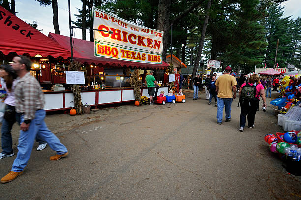 Deerfield Fair Food Vendors Deerfield NH, USA - September 30, 2011: People eating and hanging out around a very old Deerfield Fair concessionaire offering American foods like Texan BBQ. mike cherim stock pictures, royalty-free photos & images