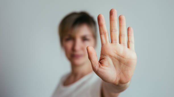 Defense or stop gesture: Female hand with stop gesture stock photo