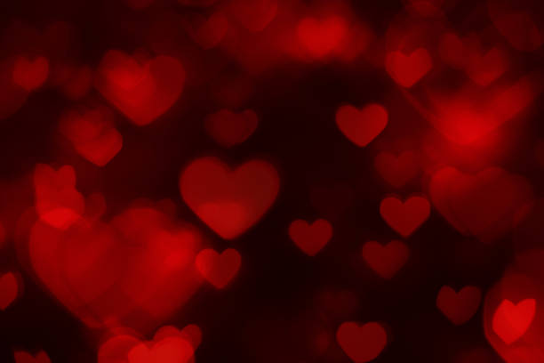 Defocused background with red heart shapes stock photo