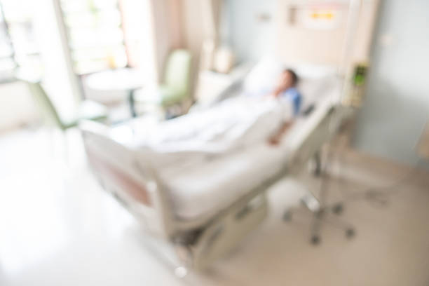 Defocused image of patient lying down the bed in hospital stock photo