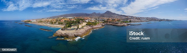 istock 180 degree aerial panorama of Costa Adeje resort and Playa del Duque beach, Tenerife, Canary islands, Spain. 1303026821