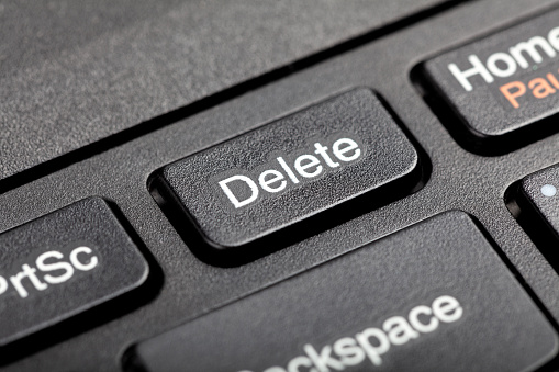 Delete key, del button on a laptop keyboard, object macro, extreme closeup, detail. User file deletion, traces removal, erasing information, getting rid of digital data abstract concept, nobody