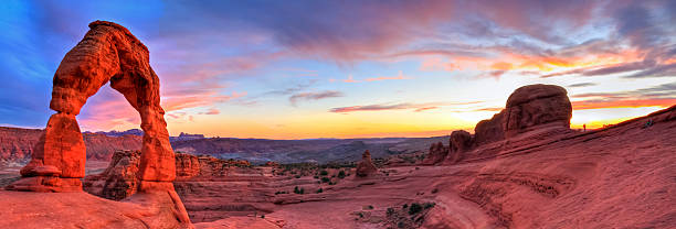 Delicate Arch HDR Sunset Panorama "Sweeping sunset panoramic view of famous Delicate Arch in Arches National Park in Moab, Utah (HDR)." arches national park stock pictures, royalty-free photos & images