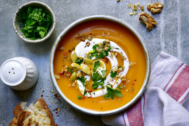 Delicious autumn pumpkin soup with cream and walnuts stock photo