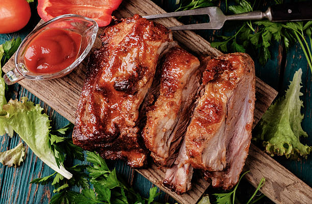 Delicious barbecued ribs seasoned with a spicy basting sauce stock photo