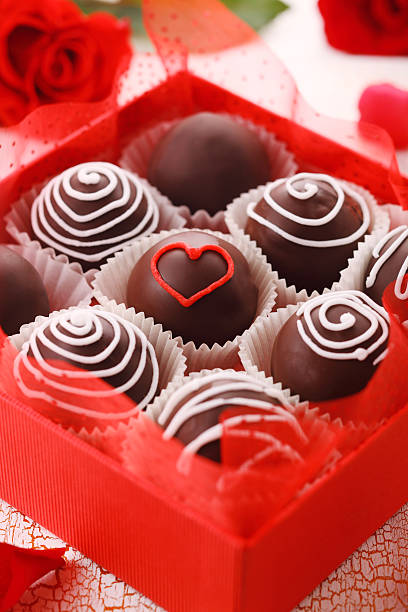 Delicious chocolate pralines  in red box for Valentine's Day, stock photo