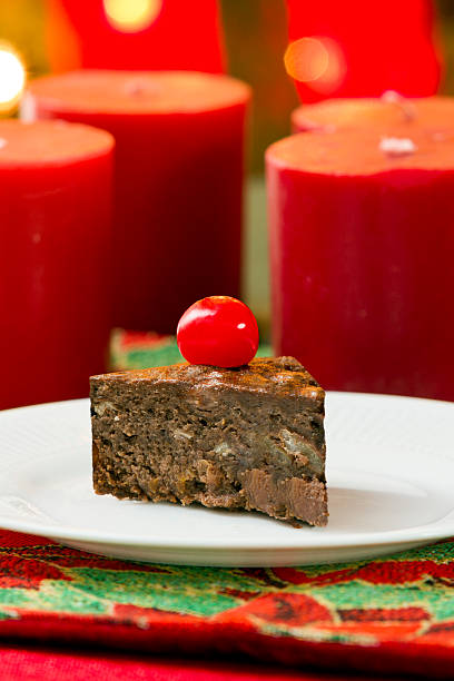 Delicious Christmas cake with red candles background stock photo