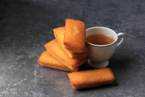 Delicious French Financiers Cake  with Fresh Butter, Served with Tea. Copy Space for Text. On Grey Cement Background Delicious French Financiers Cake  with Fresh Butter, Served with Tea. Copy Space for Text. On Grey Cement Background financiers with almonds stock pictures, royalty-free photos & images