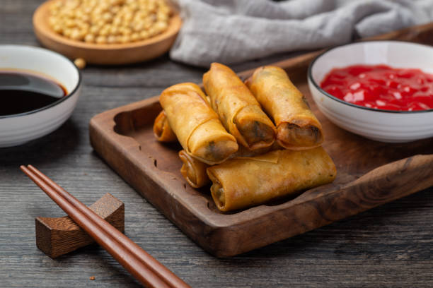 Delicious fried spring rolls and sweet chili sauce stock photo