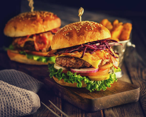 Delicious homemade hamburger on wooden background stock photo