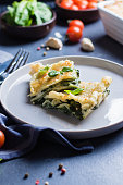 Delicious homemade lasagne with ricotta cheese and spinach on blue stone concreet table background. Vegetarian Food. Italian Food