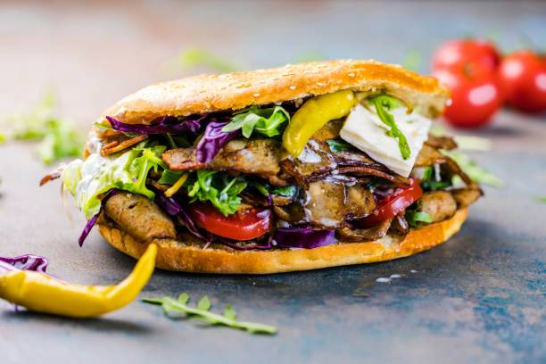 Delicious kebab sandwich on wooden background stock photo