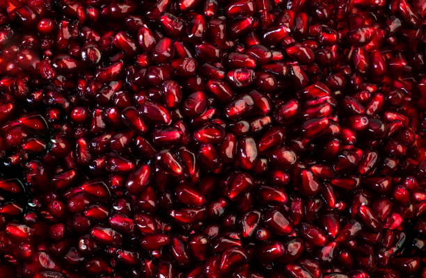 Delicious mature red ripe juicy pomegranate seeds background texture pattern. stock photo