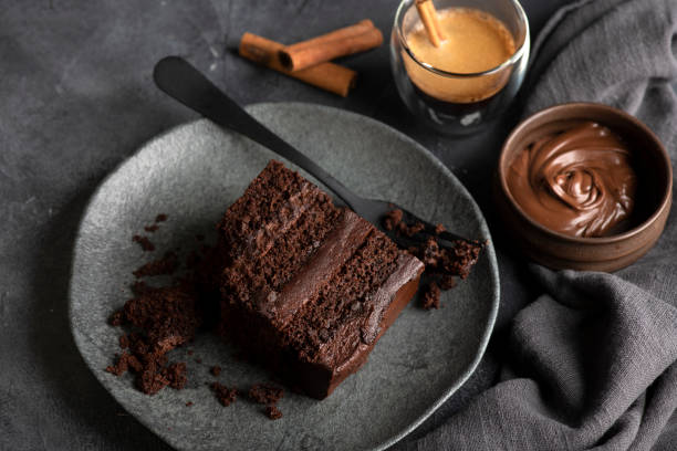 Delicious slice of cake. Sweet dark chocolate Indulgence. chocolate cake stock pictures, royalty-free photos & images