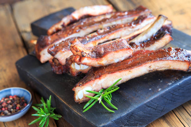 delicious spareribs on wooden board stock photo