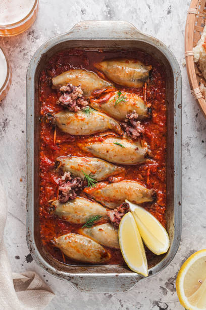 Delicious stuffed squids with tomato sauce stock photo