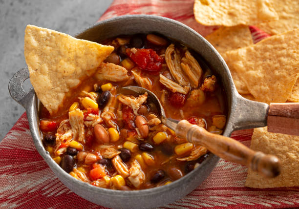 Delicious taco chicken soup with tortillia chips stock photo