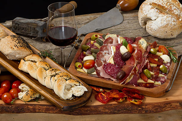 Delicious typical argentinean gourmet antipasto Mix of typical argentinean cheeses and cold cuts with argentinean red wine on ancient wood table - Still life argentina food stock pictures, royalty-free photos & images