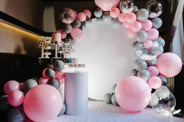 Delicious wedding reception. Birthday Cake on a background balloons party decor. Copy space. Celebration concept. Trendy Cake. Candy bar. Table with sweets, candies, dessert. stock photo
